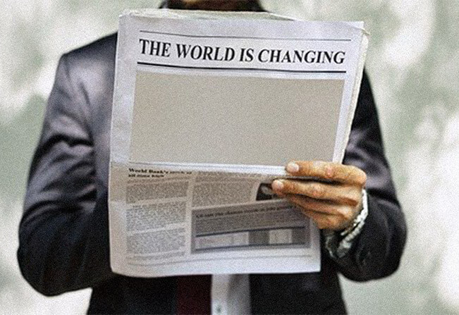 Man reading newspaper that says the world is changing