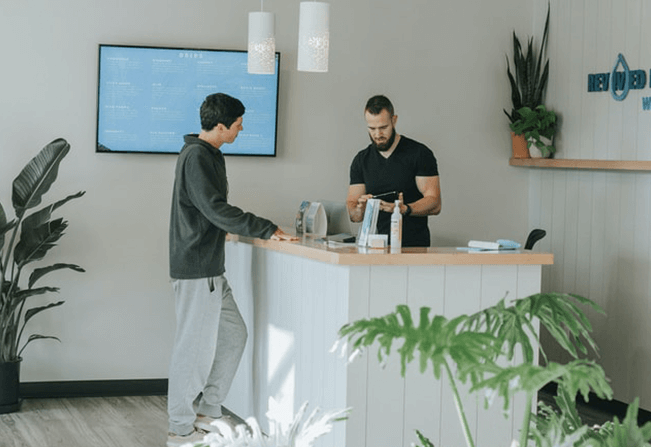 Man signing into visitor management system